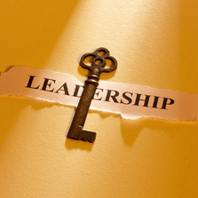 key sitting on top of a piece of paper with the word &quot;leadership&quot; written on it